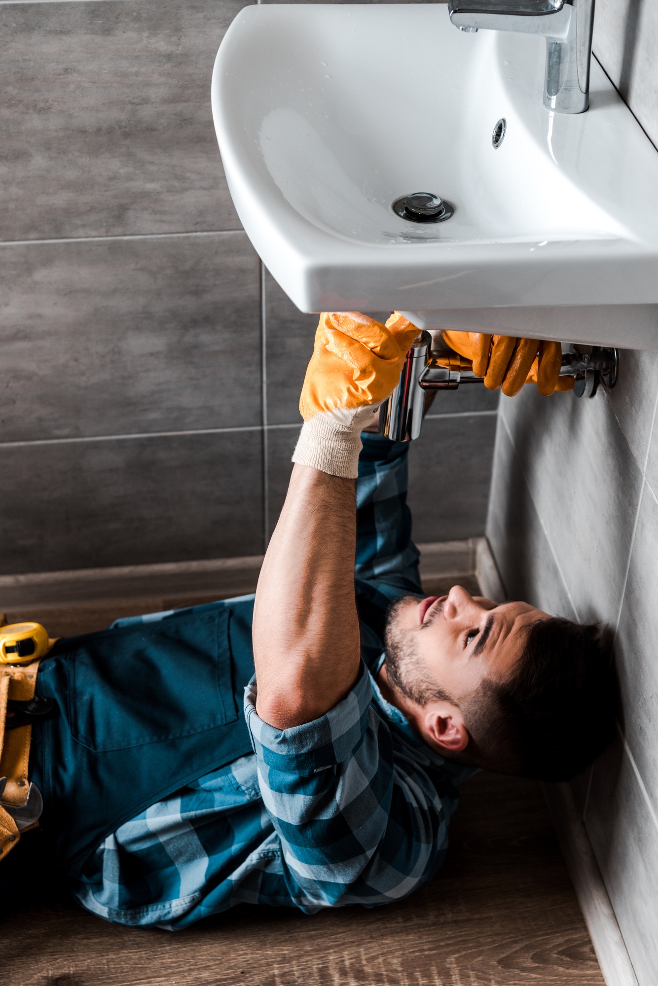 Plumber fixing water pipe leak
